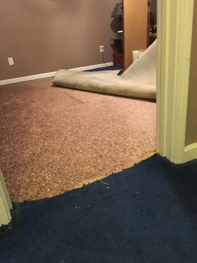 Carpet pad removal revealing water damage during Water Mitigation Services in Pomona